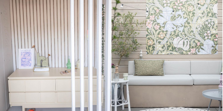 Cupboard with art print frame and small vases with flowers. Garden sofa with green cushion and art print on the wall.