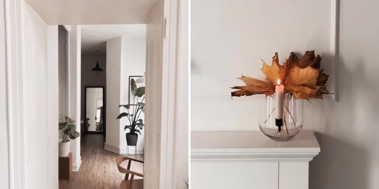 Open door, house plants, wooden chair. Enlighted candle on fireplace with orange leaves behind.